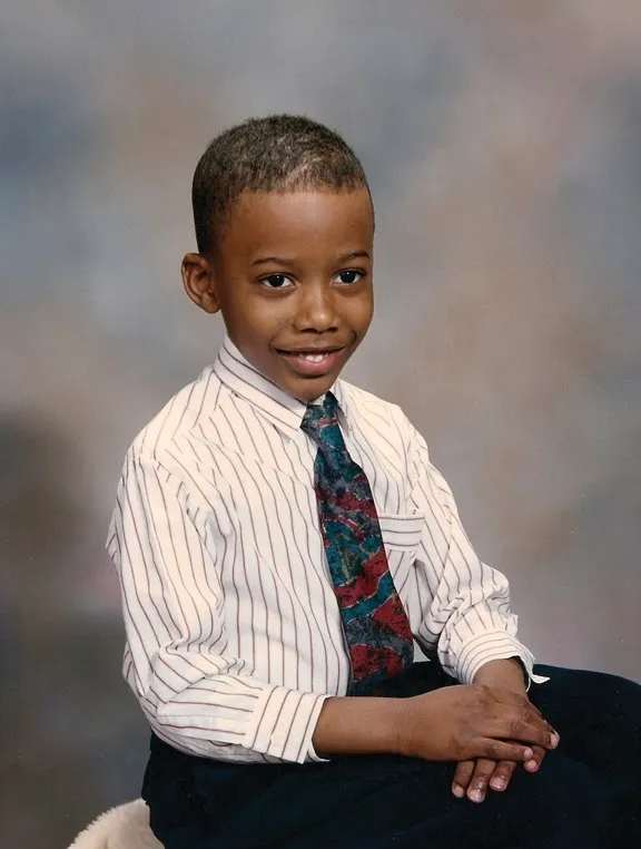 Ryan Crawford as a schoolboy, in a striped shirt and patterned tie